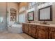 Spa-like bathroom featuring a soaking tub, dual vanities, and elegant fixtures for a luxurious experience at 5077 E Lonesome Trl, Cave Creek, AZ 85331