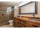 Bathroom featuring wood-style shower, stone flooring, and copper sinks at 5077 E Lonesome Trl, Cave Creek, AZ 85331