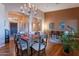 Elegant dining room featuring a chandelier, wood floors, and a seamless flow into other living areas at 5077 E Lonesome Trl, Cave Creek, AZ 85331