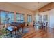 Elegant dining room with hardwood floors, grand piano, and ample natural light at 5077 E Lonesome Trl, Cave Creek, AZ 85331