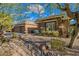 Attractive home exterior with desert landscaping, a three-car garage, and a well-maintained facade at 5077 E Lonesome Trl, Cave Creek, AZ 85331