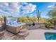 Beautiful hot tub on a stone patio with desert landscape, next to pool at 5077 E Lonesome Trl, Cave Creek, AZ 85331