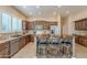 Rustic kitchen featuring custom wood cabinets, granite countertops, and a breakfast bar at 5077 E Lonesome Trl, Cave Creek, AZ 85331