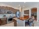 Well-equipped kitchen with stainless steel appliances, granite countertops, and a breakfast bar at 5077 E Lonesome Trl, Cave Creek, AZ 85331