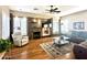 Cozy living room with a stone fireplace, built-in shelves, and a comfortable seating area at 5077 E Lonesome Trl, Cave Creek, AZ 85331