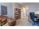 Cozy office space with built-in bookcase, accent chair, and neutral tile at 5077 E Lonesome Trl, Cave Creek, AZ 85331