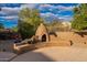 Backyard pizza oven made of brick, with wood for burning, located in landscaped yard at 5077 E Lonesome Trl, Cave Creek, AZ 85331