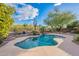 Backyard pool area showcasing the pool with a built-in waterfall feature and desert landscaping at 5077 E Lonesome Trl, Cave Creek, AZ 85331