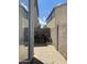 Cozy patio area with pavers, grill, and a view of the clear sky and the surrounding buildings at 6614 W Polk St, Phoenix, AZ 85043