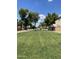 Well-maintained green space in a common area surrounded by trees and lush grass at 6614 W Polk St, Phoenix, AZ 85043