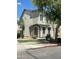 Two-story home featuring a stucco exterior, a stone-accented entrance, and shade trees at 6614 W Polk St, Phoenix, AZ 85043