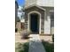 Close-up of the front entrance featuring a stone-accented entry and a blue front door at 6614 W Polk St, Phoenix, AZ 85043