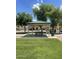 Shaded gazebo with picnic table, perfect for outdoor dining and relaxation in a green, grassy area at 6614 W Polk St, Phoenix, AZ 85043