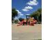 Colorful playground with slides, climbing structures, and a soft sand base at 6614 W Polk St, Phoenix, AZ 85043