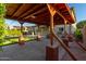 Covered back patio with brick pillars, ceiling fan, and expansive artificial turf at 6632 W Saguaro Park Ln, Glendale, AZ 85310