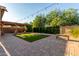 Backyard featuring artificial turf, and covered patio with string lights, perfect for entertaining at 6632 W Saguaro Park Ln, Glendale, AZ 85310