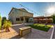 Backyard featuring a patio, pergola, artificial turf and outdoor fireplace perfect for entertaining at 6632 W Saguaro Park Ln, Glendale, AZ 85310