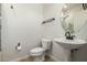 Compact bathroom features a pedestal sink and classic fixtures at 6632 W Saguaro Park Ln, Glendale, AZ 85310