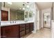 A bathroom features dual sinks, tiled wall accents, and a glass shower at 6632 W Saguaro Park Ln, Glendale, AZ 85310