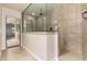 A bathroom has neutral tile floors and a glass shower stall at 6632 W Saguaro Park Ln, Glendale, AZ 85310