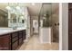The bathroom has tile floors, a double vanity, and a separate glass shower at 6632 W Saguaro Park Ln, Glendale, AZ 85310