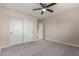 Bedroom with double closet offers space and neutral carpet at 6632 W Saguaro Park Ln, Glendale, AZ 85310