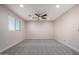 An oversized bedroom has neutral walls, recessed lights and large windows at 6632 W Saguaro Park Ln, Glendale, AZ 85310