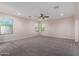 An oversized bedroom has neutral walls, recessed lights and large windows at 6632 W Saguaro Park Ln, Glendale, AZ 85310