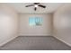 Bedroom includes carpet, ceiling fan, and natural light from the window at 6632 W Saguaro Park Ln, Glendale, AZ 85310