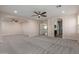 A large bedroom has neutral walls, recessed lights, ceiling fans, and windows at 6632 W Saguaro Park Ln, Glendale, AZ 85310
