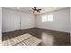 A cozy bedroom has wood floors and a ceiling fan at 6632 W Saguaro Park Ln, Glendale, AZ 85310
