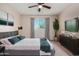 A bedroom featuring a full bed, a decorative plant and light-blocking curtains for optimal comfort at 6632 W Saguaro Park Ln, Glendale, AZ 85310