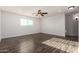A spacious bedroom has wood floors and a ceiling fan at 6632 W Saguaro Park Ln, Glendale, AZ 85310