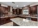 Large kitchen with island, granite countertops, tiled backsplash, and stainless appliances at 6632 W Saguaro Park Ln, Glendale, AZ 85310