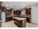 Spacious kitchen featuring an island, granite countertops, and modern stainless steel appliances at 6632 W Saguaro Park Ln, Glendale, AZ 85310