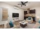 A modern living room with a partial kitchen view, sleek furniture, and a television for entertainment at 6632 W Saguaro Park Ln, Glendale, AZ 85310