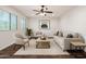 Bright and airy living room featuring hardwood floors, neutral furniture, and lots of natural light at 6632 W Saguaro Park Ln, Glendale, AZ 85310