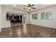 Open-concept living area with hardwood floors and seamless transition to the kitchen at 6632 W Saguaro Park Ln, Glendale, AZ 85310
