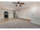 Bright open living room with high ceilings, neutral paint, and a modern ceiling fan at 6632 W Saguaro Park Ln, Glendale, AZ 85310