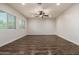 Spacious room with sleek wood-look flooring, neutral paint, and bright natural lighting at 6632 W Saguaro Park Ln, Glendale, AZ 85310