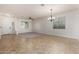 Open-concept living room with tile flooring, and neutral walls is ready for personal touches at 6632 W Saguaro Park Ln, Glendale, AZ 85310
