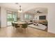Inviting living and dining area with an open concept, neutral tones, and sliding glass door leading to backyard at 6632 W Saguaro Park Ln, Glendale, AZ 85310