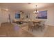 Warm and inviting living room and dining area featuring neutral tones, modern lighting, and tile flooring at 6632 W Saguaro Park Ln, Glendale, AZ 85310