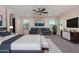Spacious main bedroom with a king bed, neutral tones, and a view of the backyard at 6632 W Saguaro Park Ln, Glendale, AZ 85310