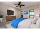 Modern main bedroom featuring a king-size bed, neutral tones, and a large television at 6632 W Saguaro Park Ln, Glendale, AZ 85310