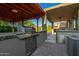 Outdoor kitchen features stainless grill, sink and brick surround that is perfect for entertaining guests at 6632 W Saguaro Park Ln, Glendale, AZ 85310