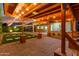 Charming covered patio area featuring string lights, a ceiling fan, and access to the backyard at 6632 W Saguaro Park Ln, Glendale, AZ 85310