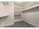 Bright walk-in closet featuring white shelving and ample storage space for an organized wardrobe at 6632 W Saguaro Park Ln, Glendale, AZ 85310