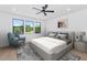 Bright bedroom with a ceiling fan, stylish chair, and a serene atmosphere at 6722 N 9Th Dr, Phoenix, AZ 85013