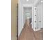 Bright and airy hallway featuring hardwood floors and a glass door, offering a clean aesthetic at 6722 N 9Th Dr, Phoenix, AZ 85013